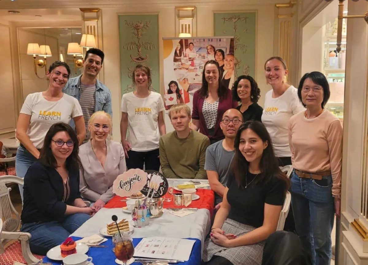 Students connecting over pastries at a Learn French community event