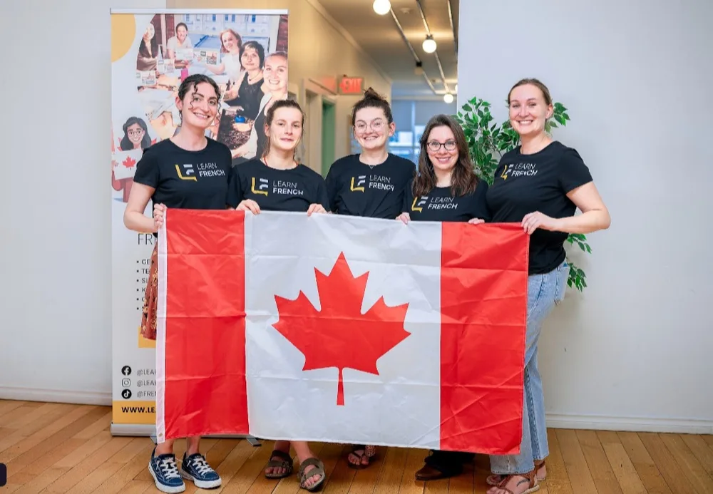 Learn French teachers holding the Canadian flag
